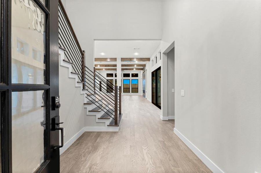 The majestic entrance showcases lofty ceilings, abundant natural light, and an inviting open floor plan.