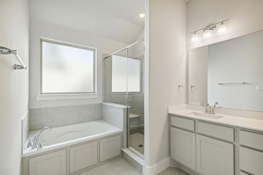 Bathroom with vanity, separate shower and tub, and vaulted ceiling