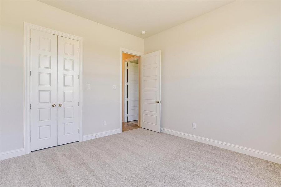 Unfurnished bedroom featuring a closet and carpet flooring