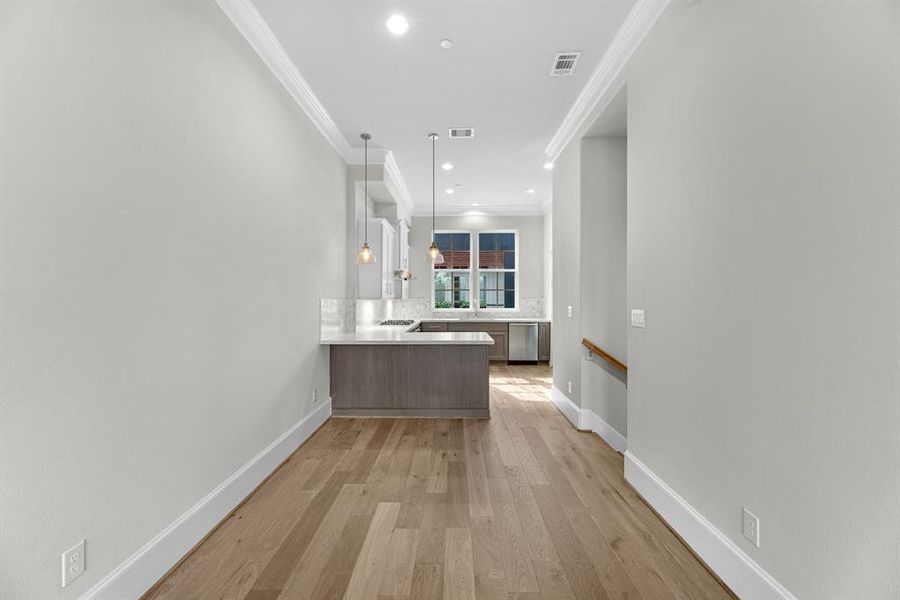 The dining area, positioned conveniently between the family room and kitchen, provides ample space for seating and entertaining.