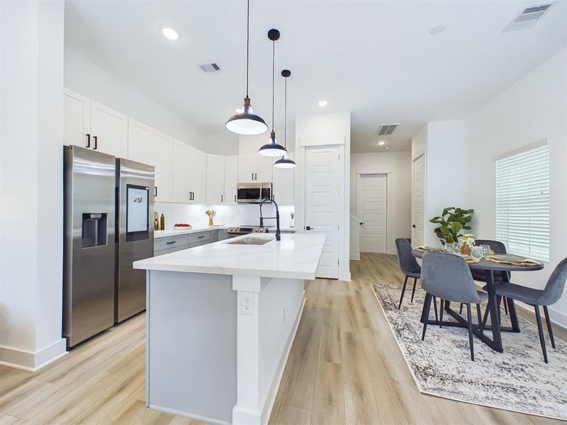 Beautiful kitchen island with plenty of space for food prep and extra sitting area.