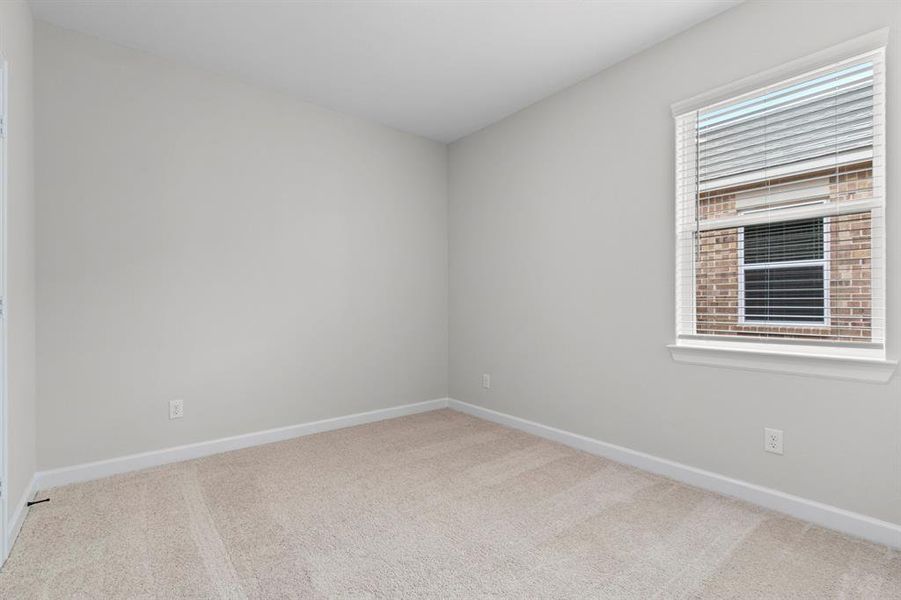 One of the two additional bedrooms in the home.