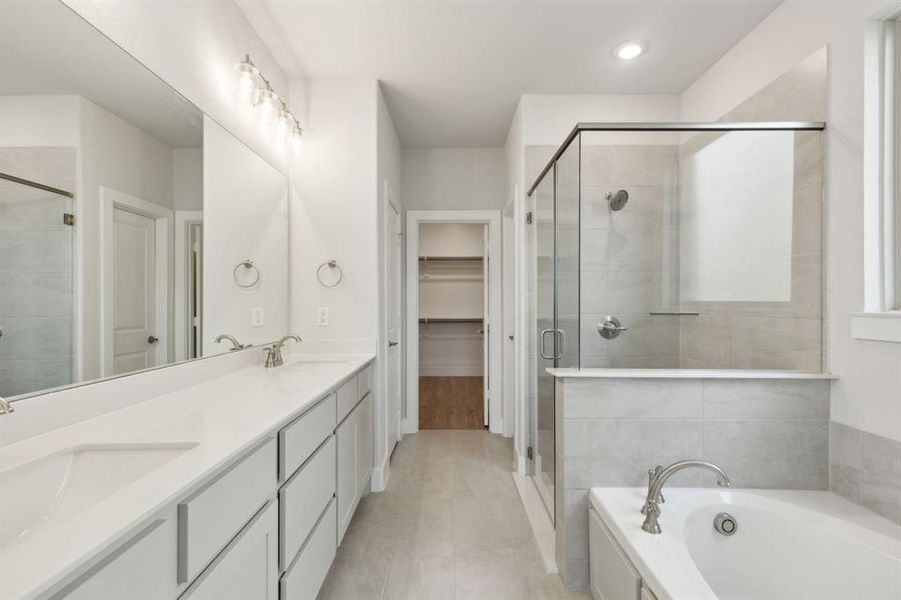 Bathroom featuring tile patterned flooring, vanity, and independent shower and bath