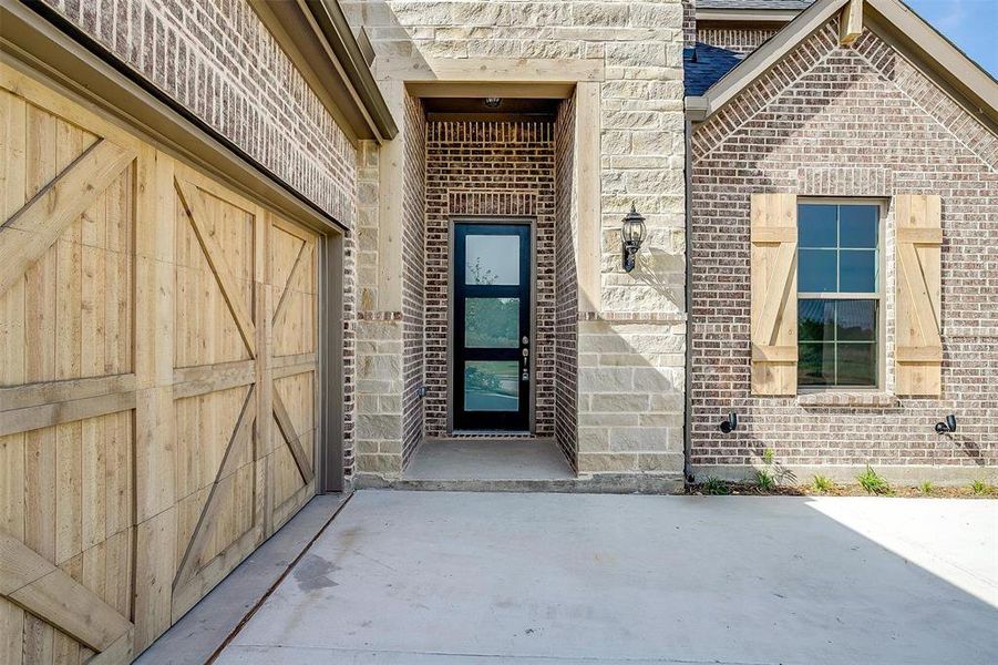 Doorway to property featuring a garage