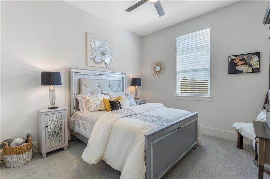 Bedroom featuring ceiling fan and light colored carpet