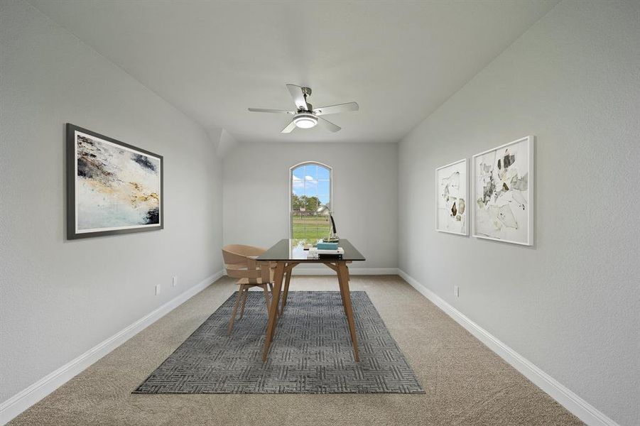 Carpeted home office featuring ceiling fan