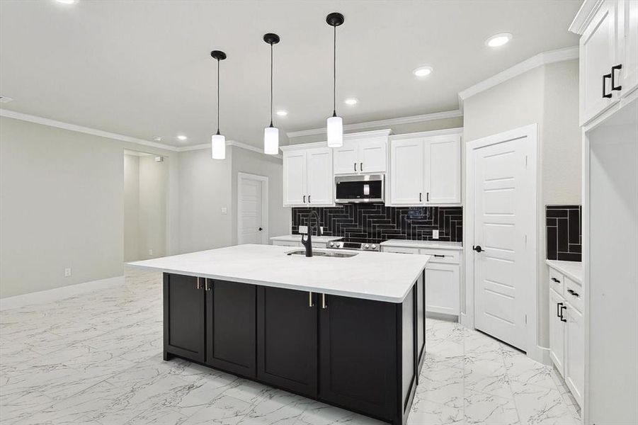 Kitchen featuring ornamental molding, white cabinets, tasteful backsplash, and light tile floors