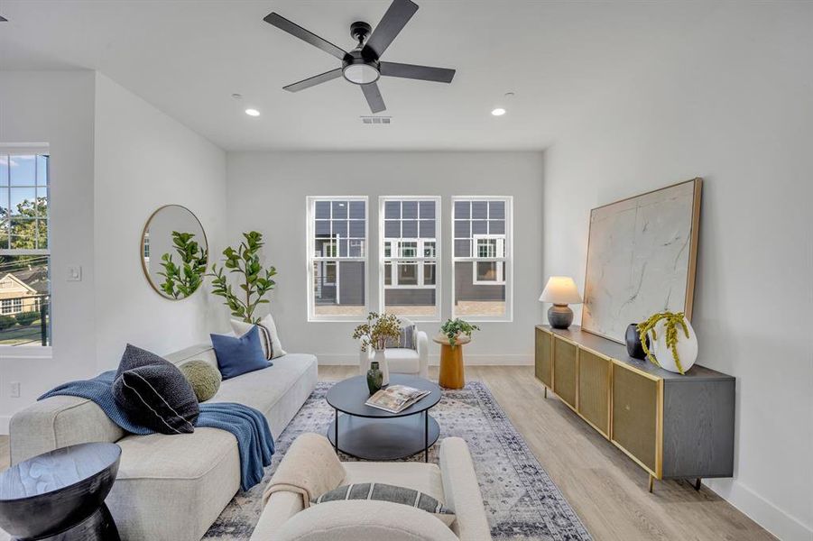 Living room featuring light hardwood / wood-style flooring and ceiling fan