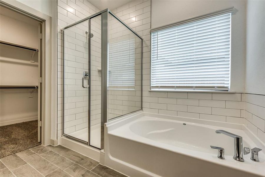 Relax in this oversized tub or enjoy this separate tiled shower.