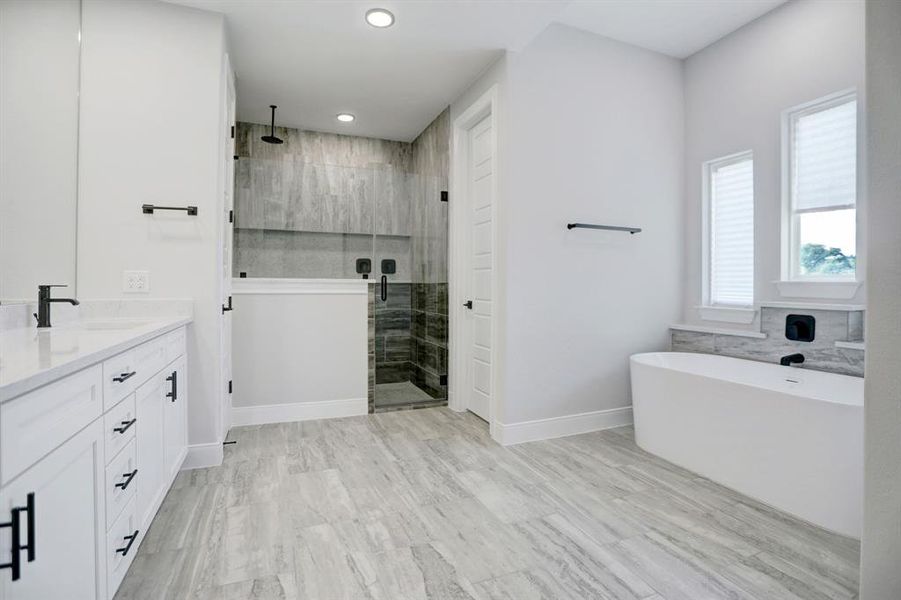 Tranquility awaits in this gorgeous owner bath with beautiful freestanding tub and spacious walk-in shower.