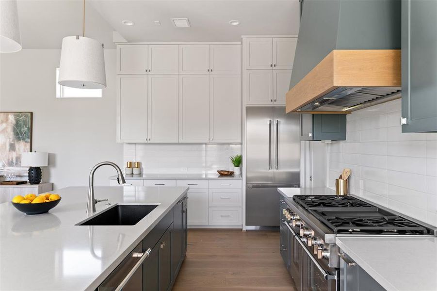 A stunning kitchen with high-end appliances is a chef's dream.Under cabinet lighteing creating a cozy environment.