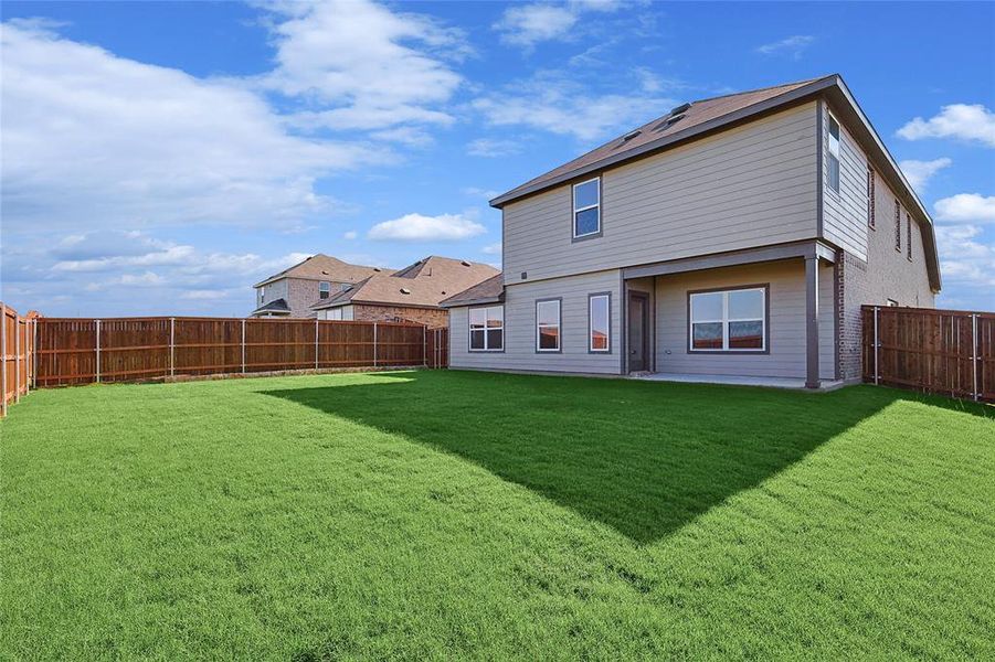 Rear view of property with a lawn