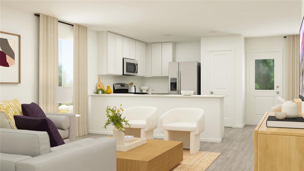 Kitchen with white cabinets, stainless steel appliances, and light wood-type flooring