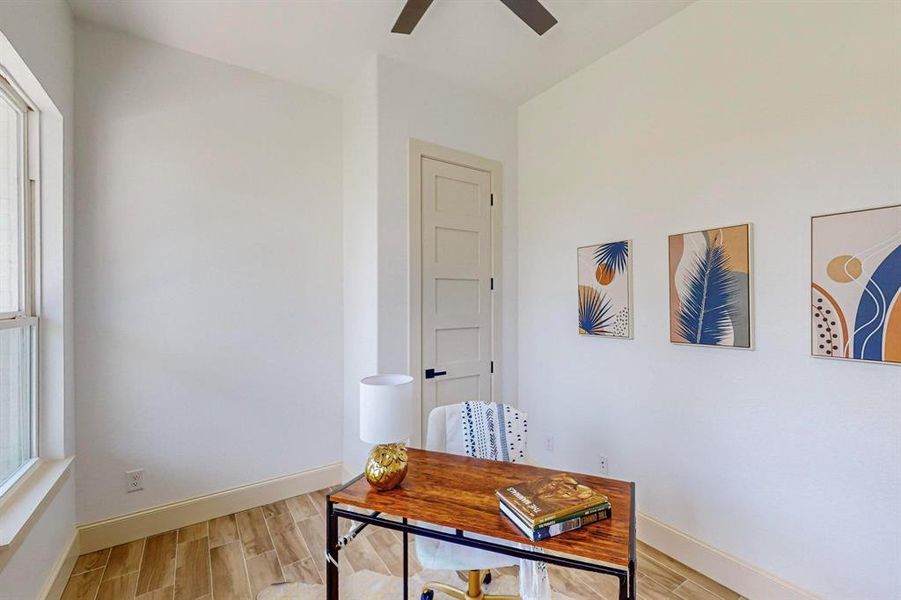 Office with plenty of natural light, ceiling fan, and light wood-type flooring