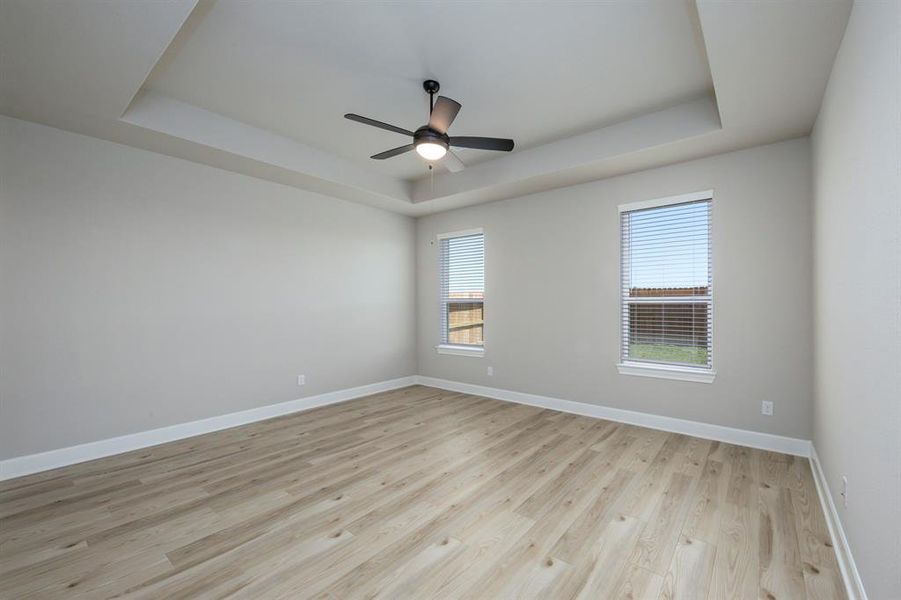 Tucked away from the additional bedrooms, the master suite boasts beautiful high celings and plenty of natural light with views into the large back yard