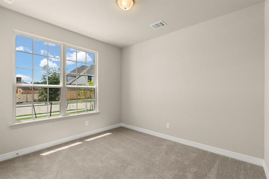 Your secondary bedroom features plush carpet, fresh paint, closet, and a large window that lets in plenty of natural lighting.