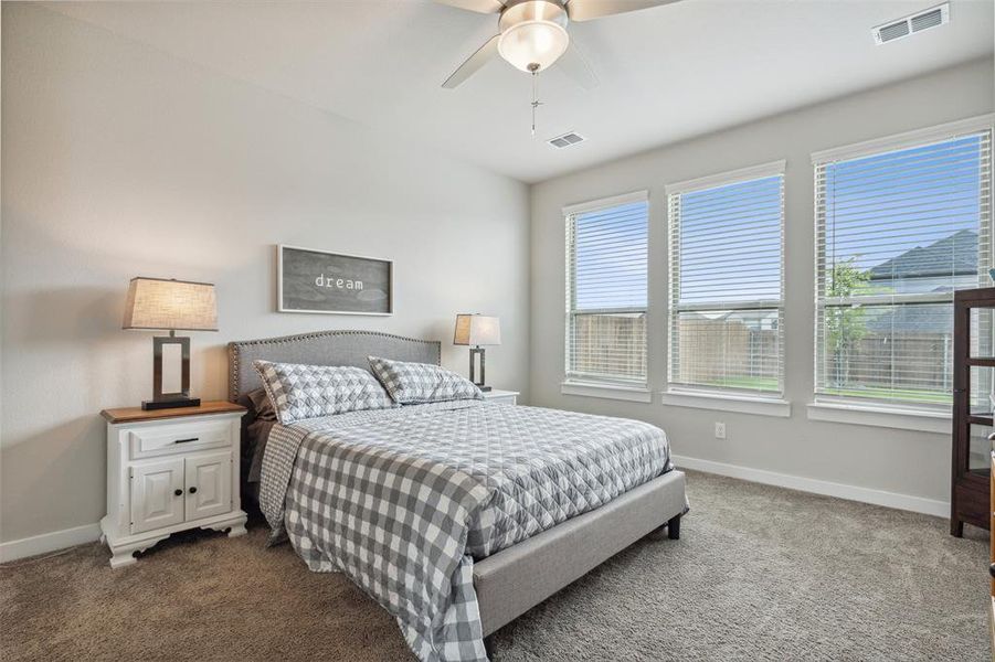 Primary bedroom retreat overlooking the backyard.