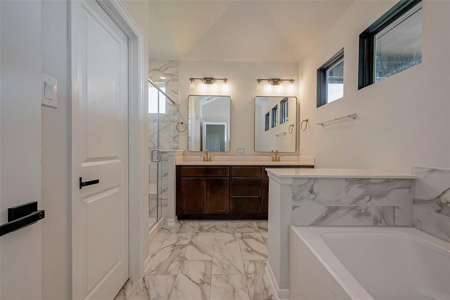 The elegant en suite is a true sanctuary, featuring a dual vanity, garden tub, and a separate shower