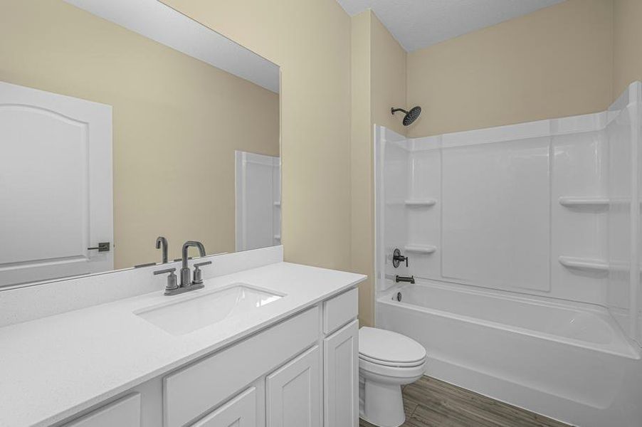 The spare bathroom has a spacious vanity ready for your guests to use
