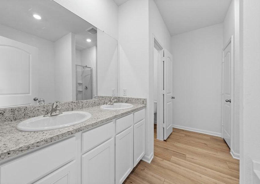 The master bathroom has two sinks and plenty of storage