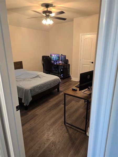 Bedroom with ceiling fan and dark hardwood / wood-style flooring