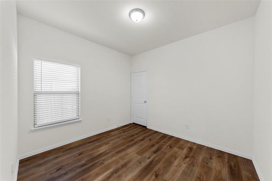 Spare room featuring dark hardwood / wood-style flooring