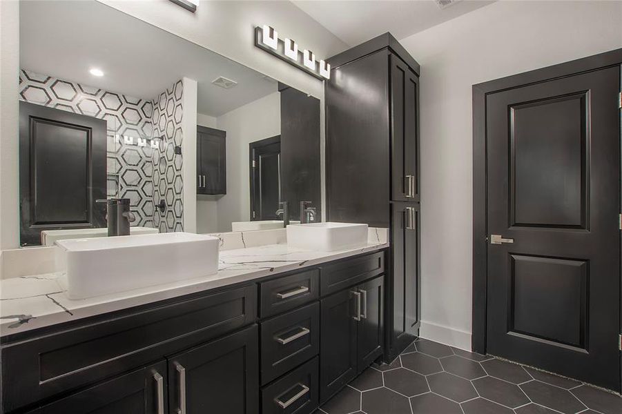 Bathroom with tile patterned flooring and vanity