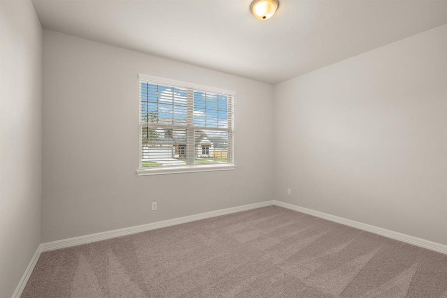 Your secondary bedroom features plush carpet, fresh paint, closet, and a large window that lets in plenty of natural lighting.