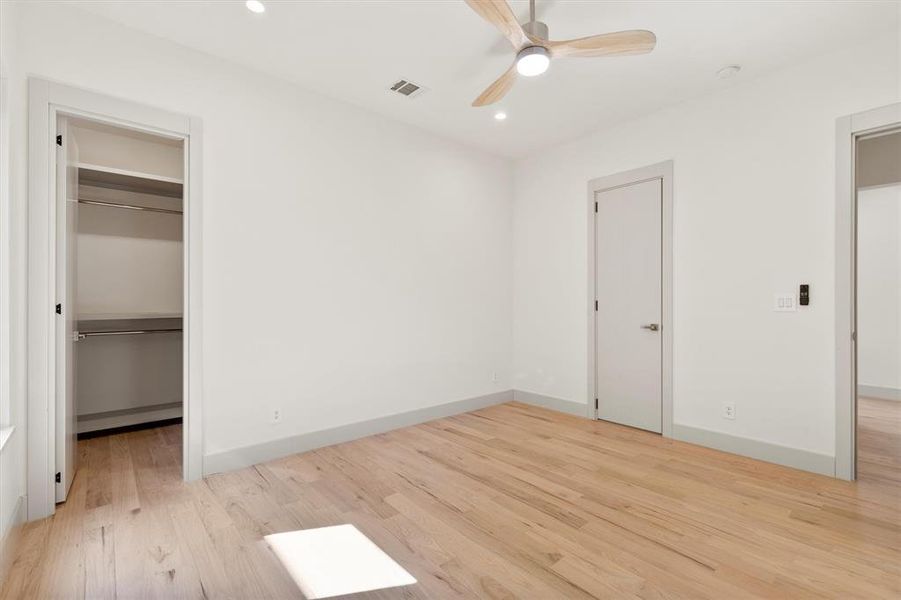 Unfurnished bedroom featuring ceiling fan and light hardwood / wood-style flooring