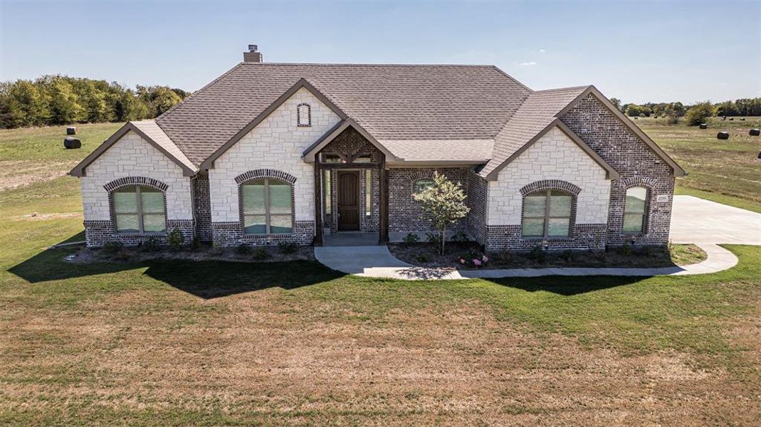 French country style house featuring a front yard