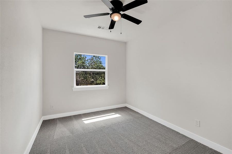 2nd Bedroom featuring ceiling fan and carpet flooring