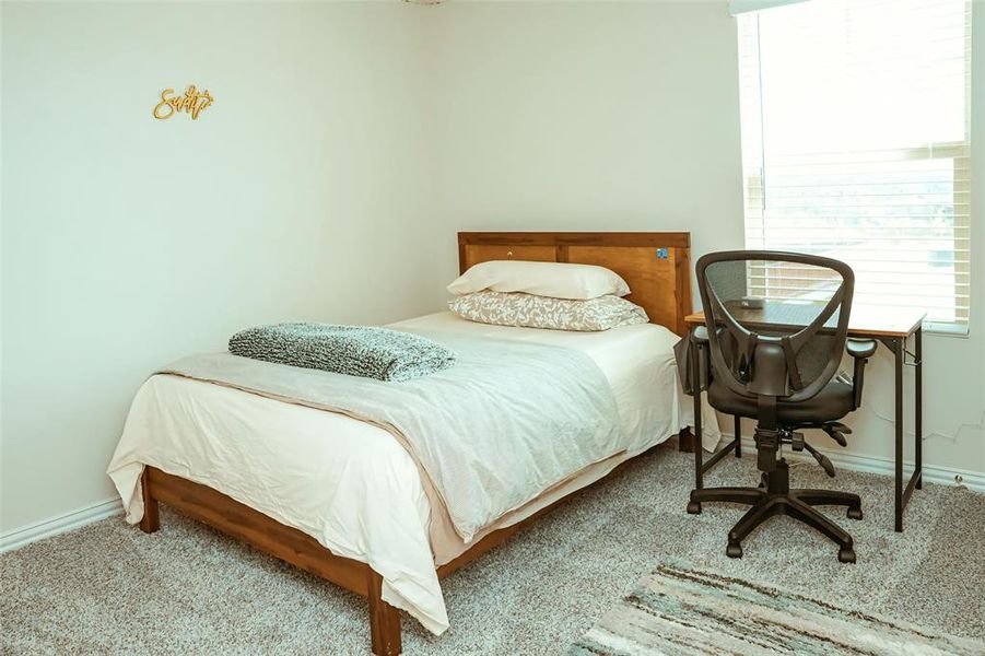 Bedroom featuring light carpet