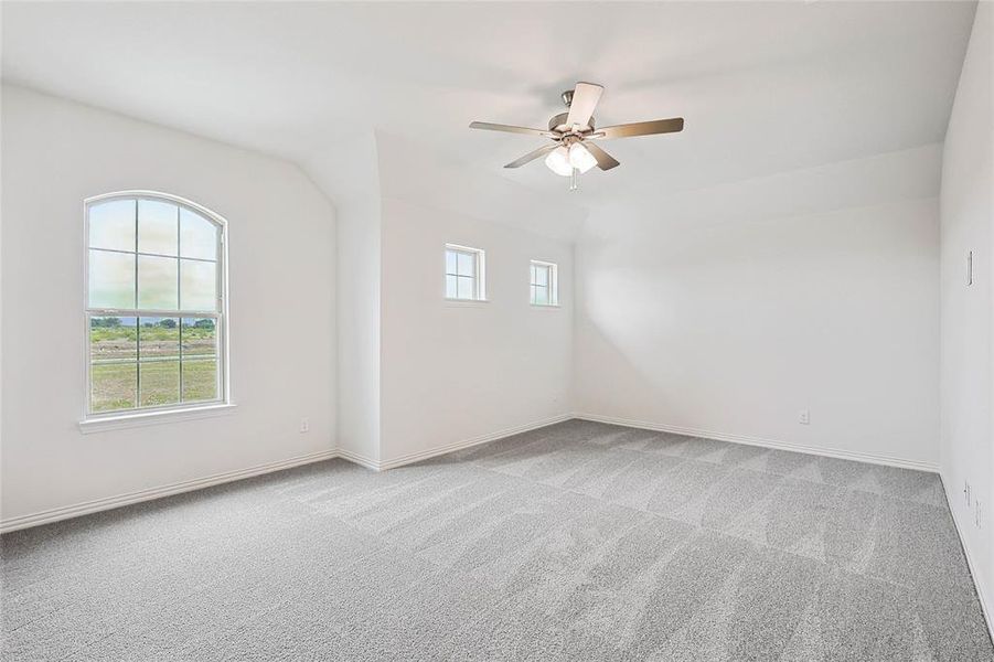 Empty room with carpet flooring and ceiling fan