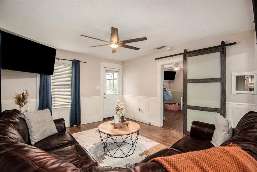 Barn doors open to living room and two bedrooms.