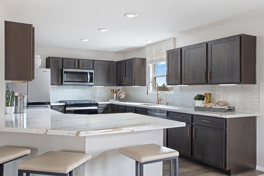 This stunning kitchen displays such a beautiful contrast with the dark stained cabinets, custom neutral paint, silestone countertops, light modern backsplash, and SS appliances including microwave and refrigerator, extended countertop for breakfast bar, recessed lighting, high ceilings, and walk in pantry!