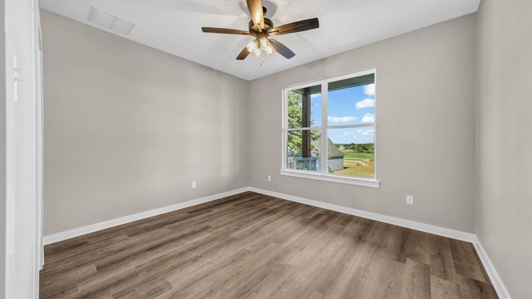 Bedroom featuring ceiling fan and LVP flooring