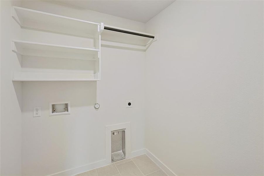 Laundry room featuring hookup for a gas dryer, hookup for a washing machine, light tile patterned floors, and hookup for an electric dryer