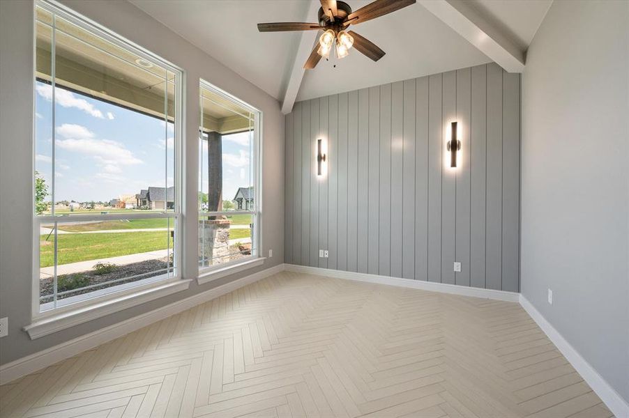 Spare room featuring beam ceiling, parquet floors, and ceiling fan