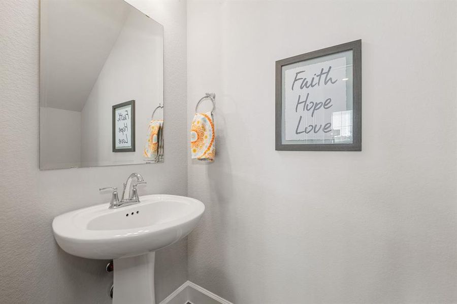 This stylish half bathroom offers both convenience and charm. Featuring modern fixtures, and elegant finishes, it’s the perfect blend of functionality and design. Ideal for guests, this well-appointed space adds a touch of sophistication to your home.