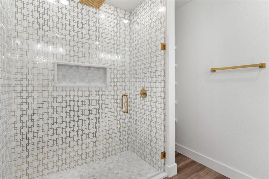 Bathroom with a shower with door and hardwood / wood-style floors