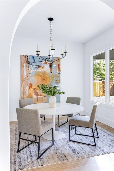 Dining room featuring a notable chandelier and wood-type flooring