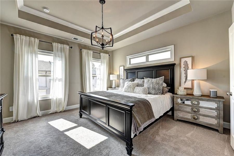 Bedroom with a tray ceiling, carpet  ***Photos NOT OF ACTUAL Home but for representation Purposes only. Home is UNDER Construction- Photos are of a previously built Model House Freemont plan by The Providence Group