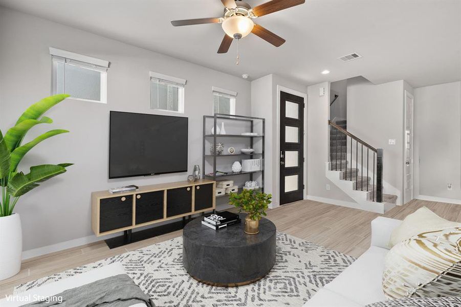 Gather the family and guests together in your lovely living room! Featuring high ceilings, dark stained ceiling fan, custom paint, gorgeous wood look tile floors and large windows that provide plenty of natural lighting throughout the day.