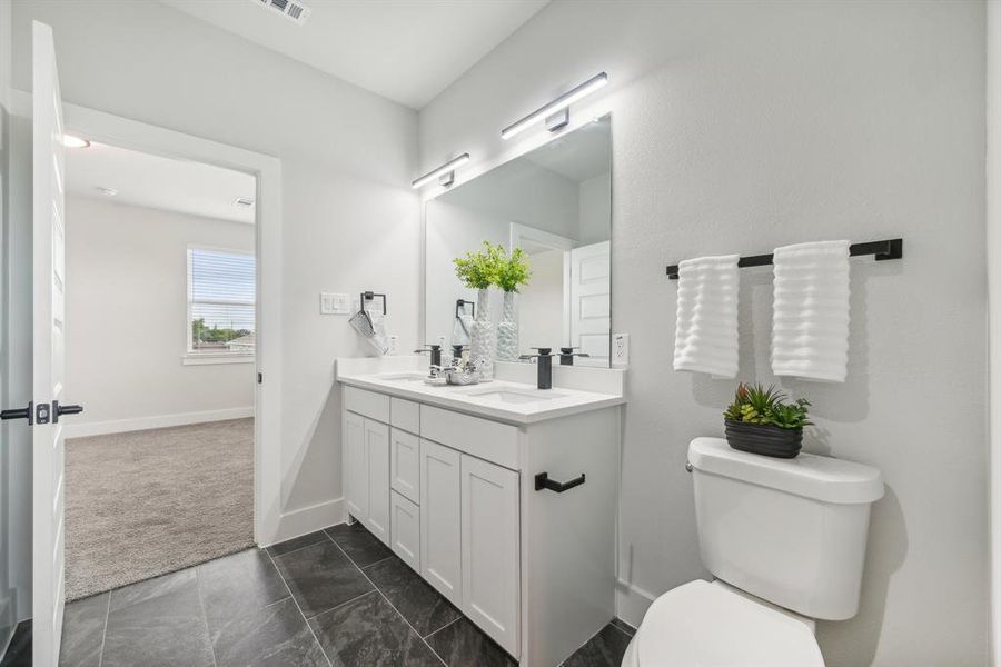 Bathroom featuring vanity and toilet