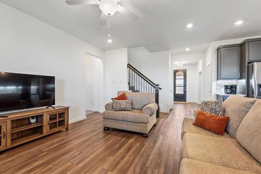 Living room featuring dark hardwood / wood-style floors and ceiling fan