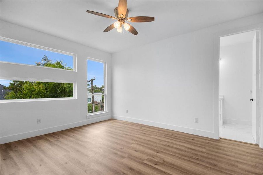 Empty room featuring ceiling fan and light wood-type flooring