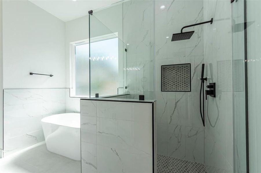 The primary shower has a built in nook for your soaps and shampoos.