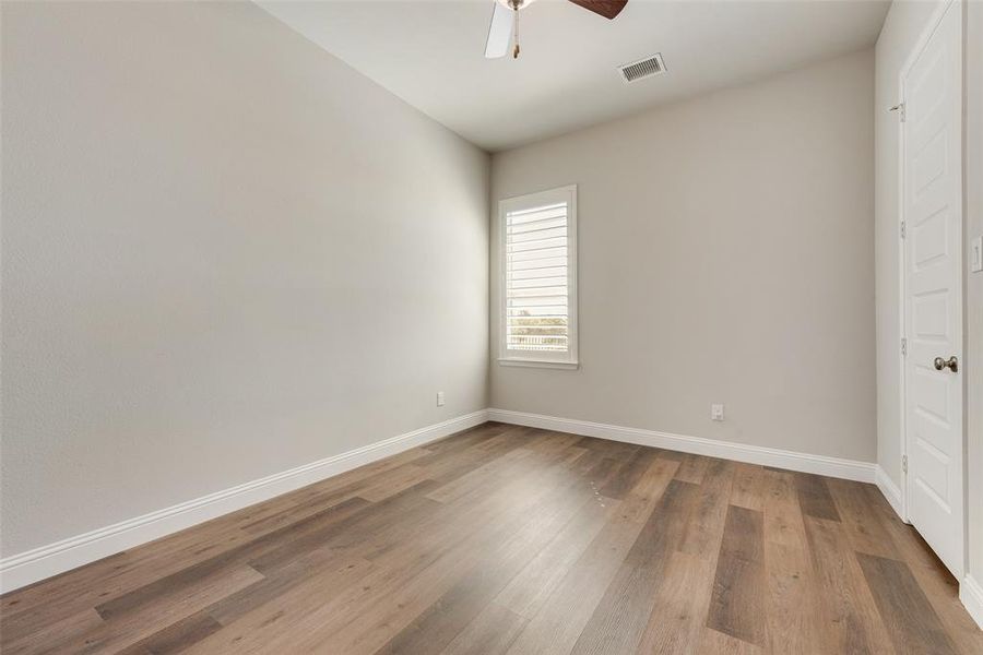 Bedroom with ceiling fan and wood-type flooring