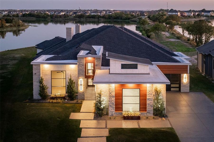 View of front of house featuring a water view and a yard