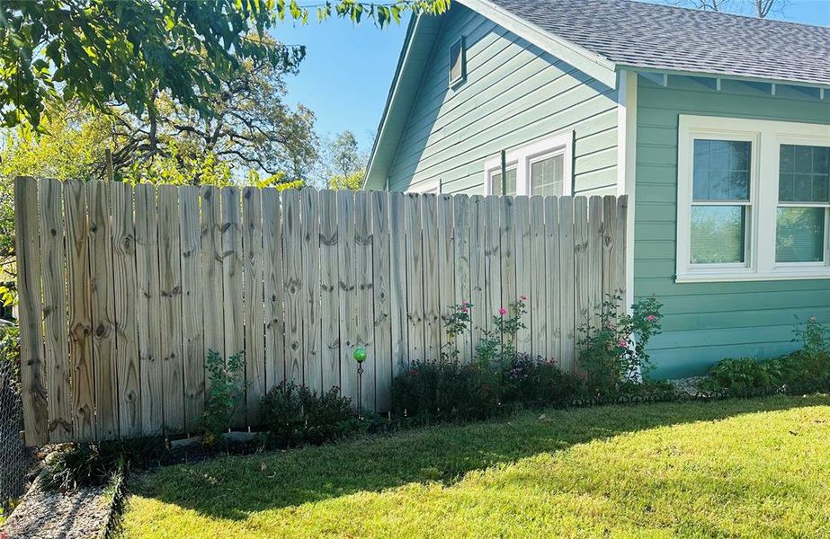 View of property exterior featuring a lawn